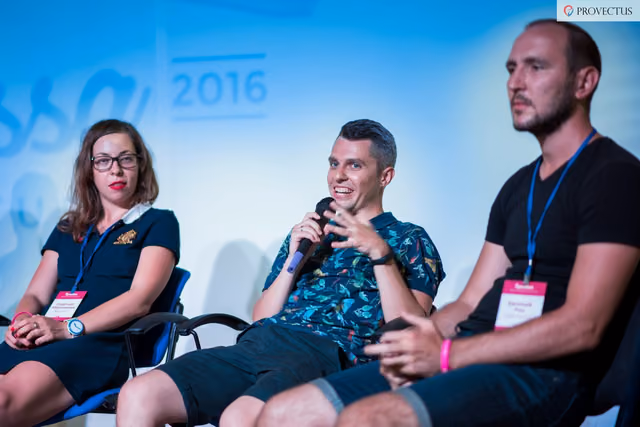 Three speakers taking part in a conference panel