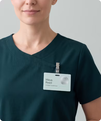 Fertility clinic coordinator in scrubs wearing a nAbleIVF staff badge