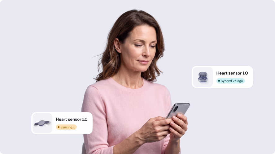 Woman syncing the Rytmo heart sensor with the mobile app by Halo Lab