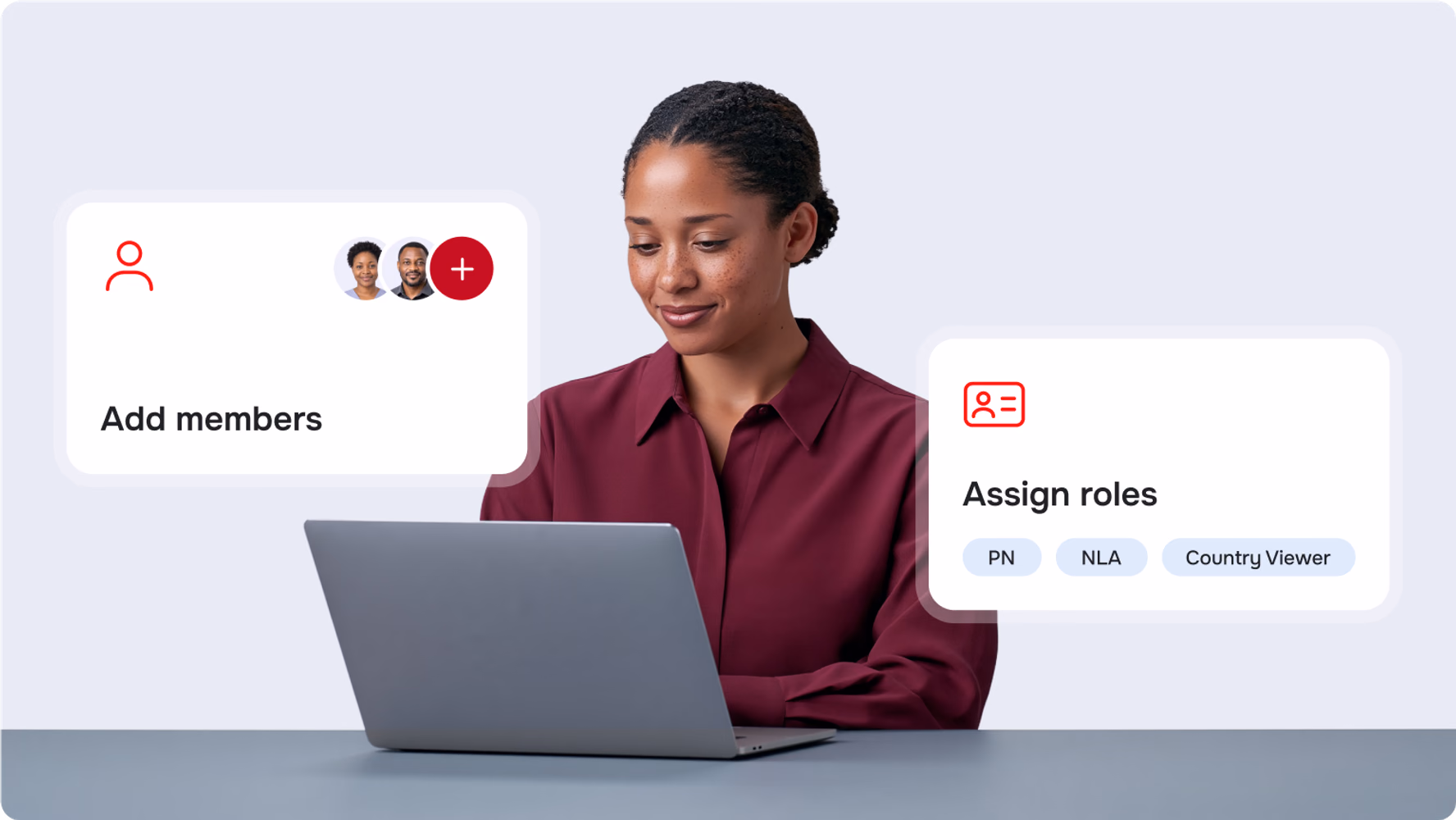Healthcare worker at a laptop with RedPath cards for adding members and assigning roles