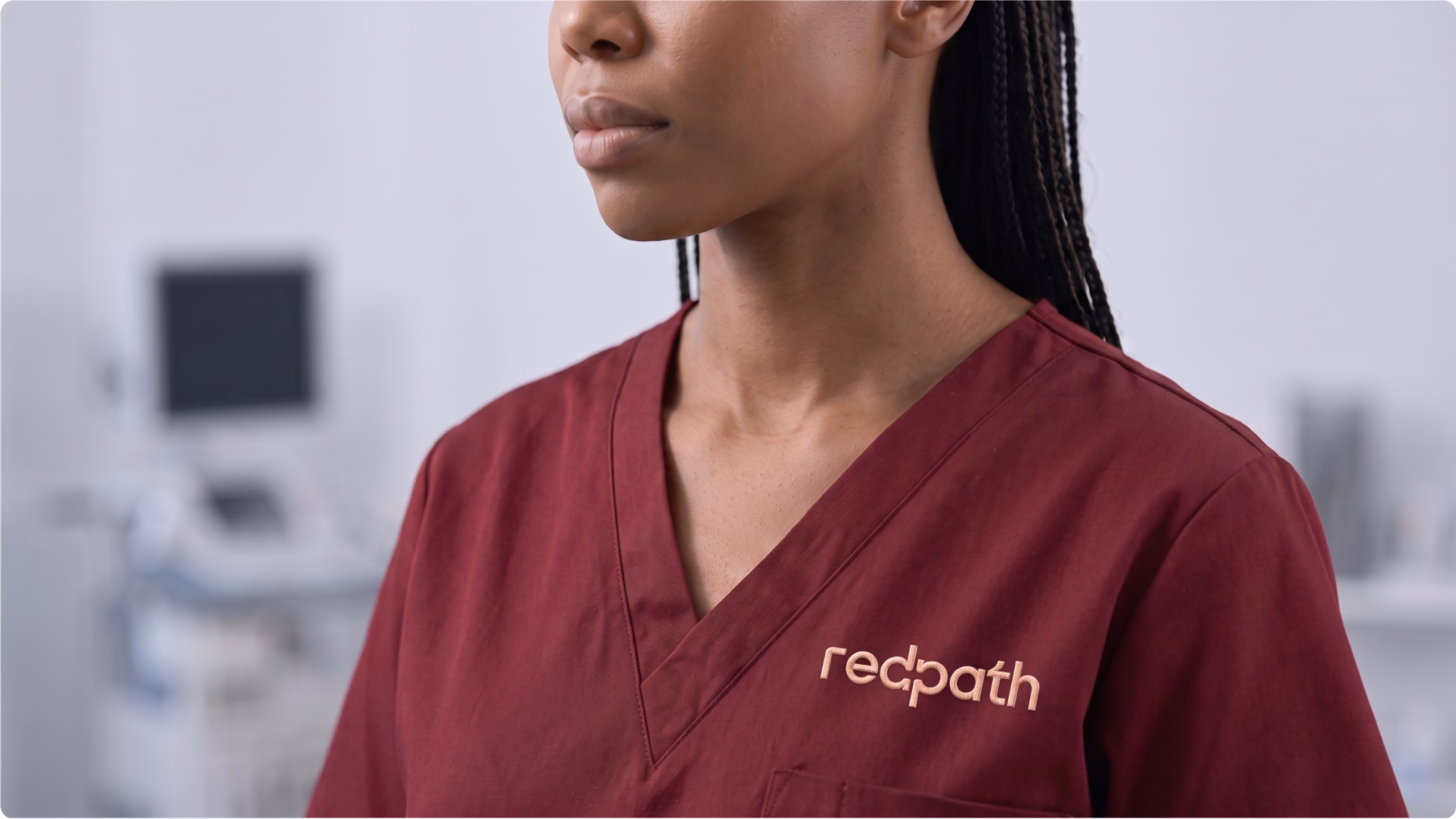 Patient navigator wearing a burgundy uniform with the RedPath logo