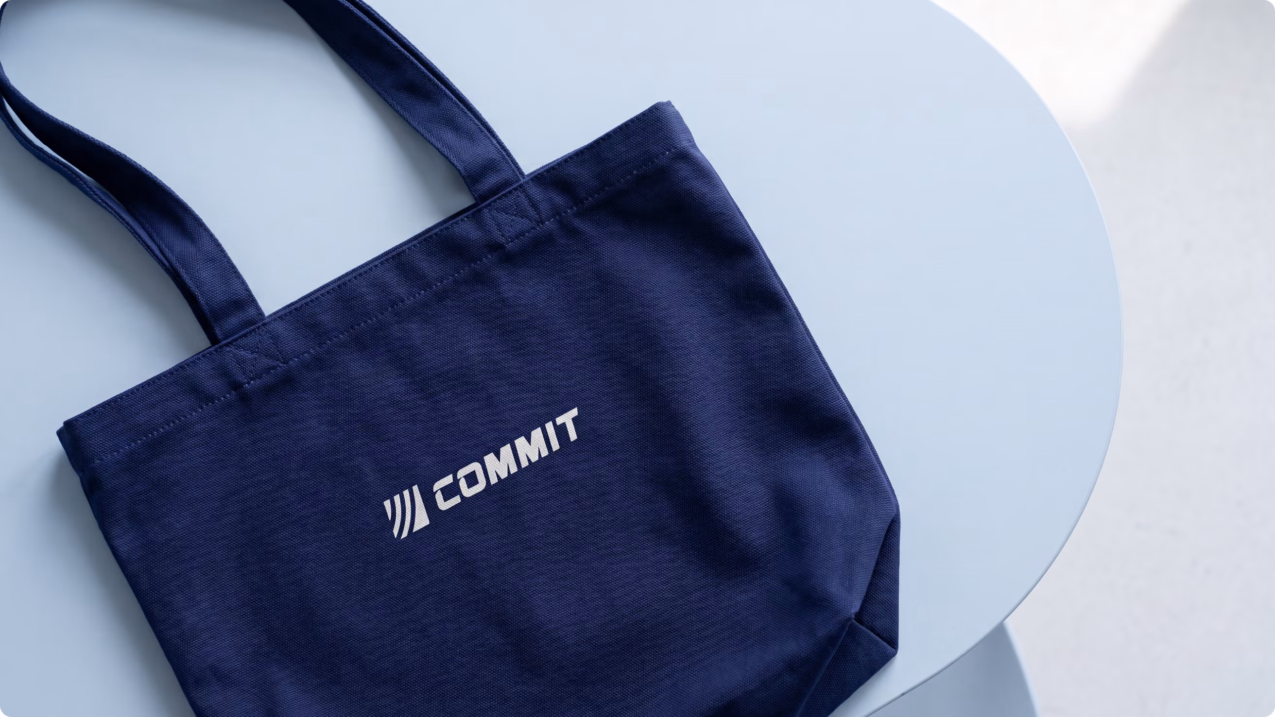 Commit Swimming tote bag on a pool deck
